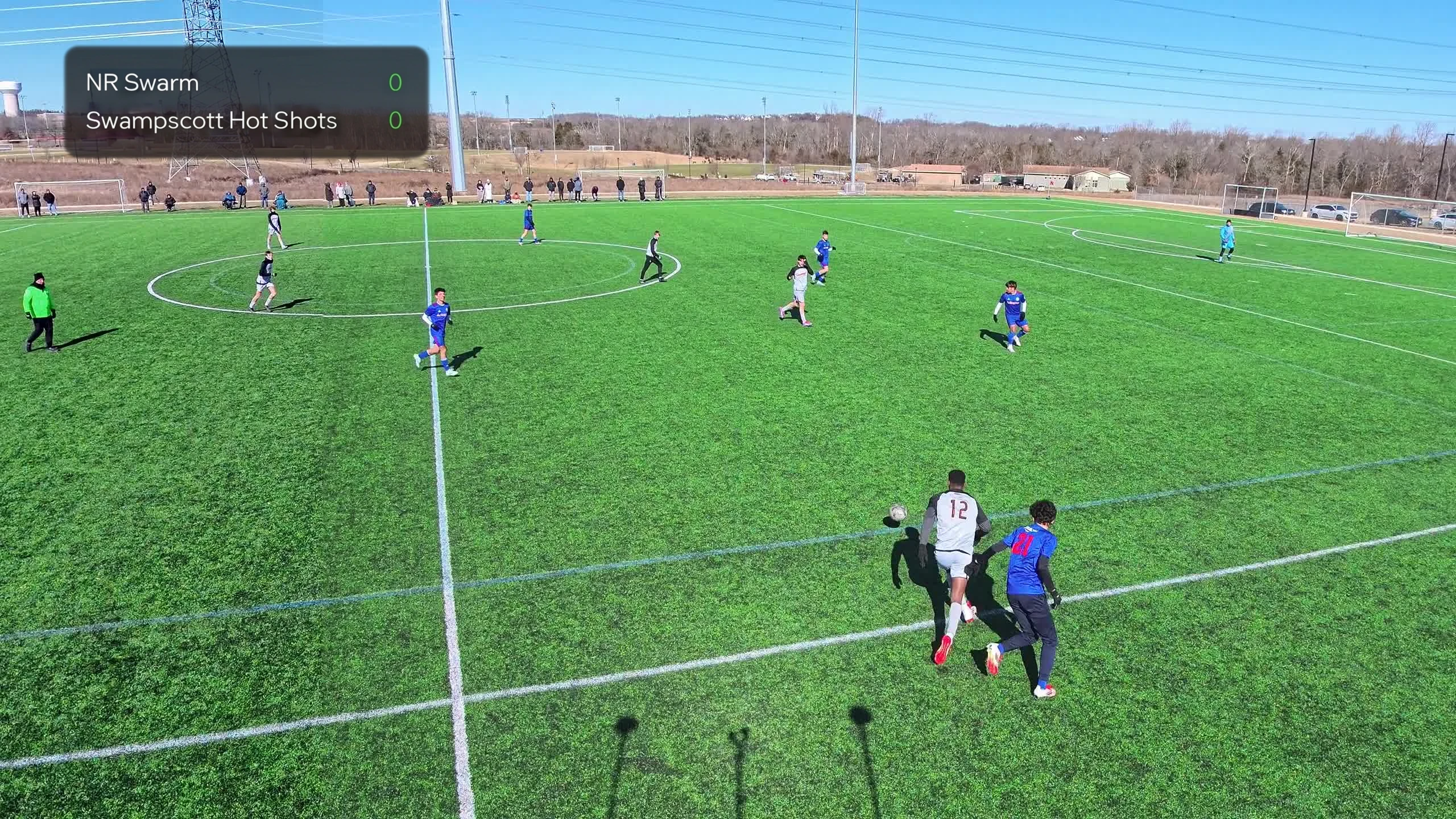 Aerial tracking of a soccer match with live scoreboard overlay